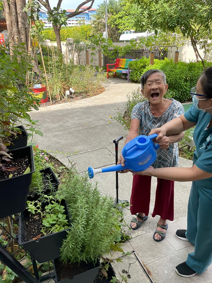Elderly woman watering garden | Apex Harmony | Greenology Academy